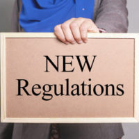 A pink sign that reads "new regulations" as laws look to improve the current system A pink sign that reads "new regulations" as laws look to improve the current system