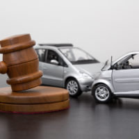 Car accident between two miniature cars behind gavel